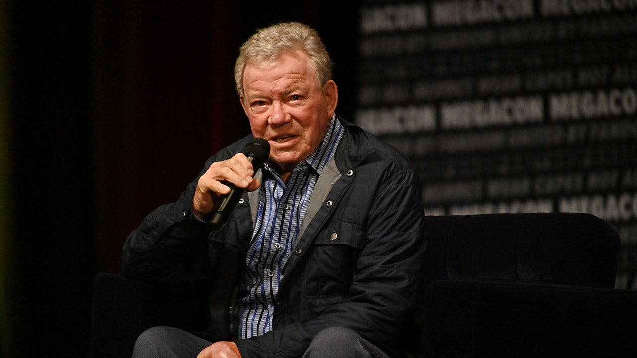 William Shatner speaks at a podium during MegaCon Orlando.