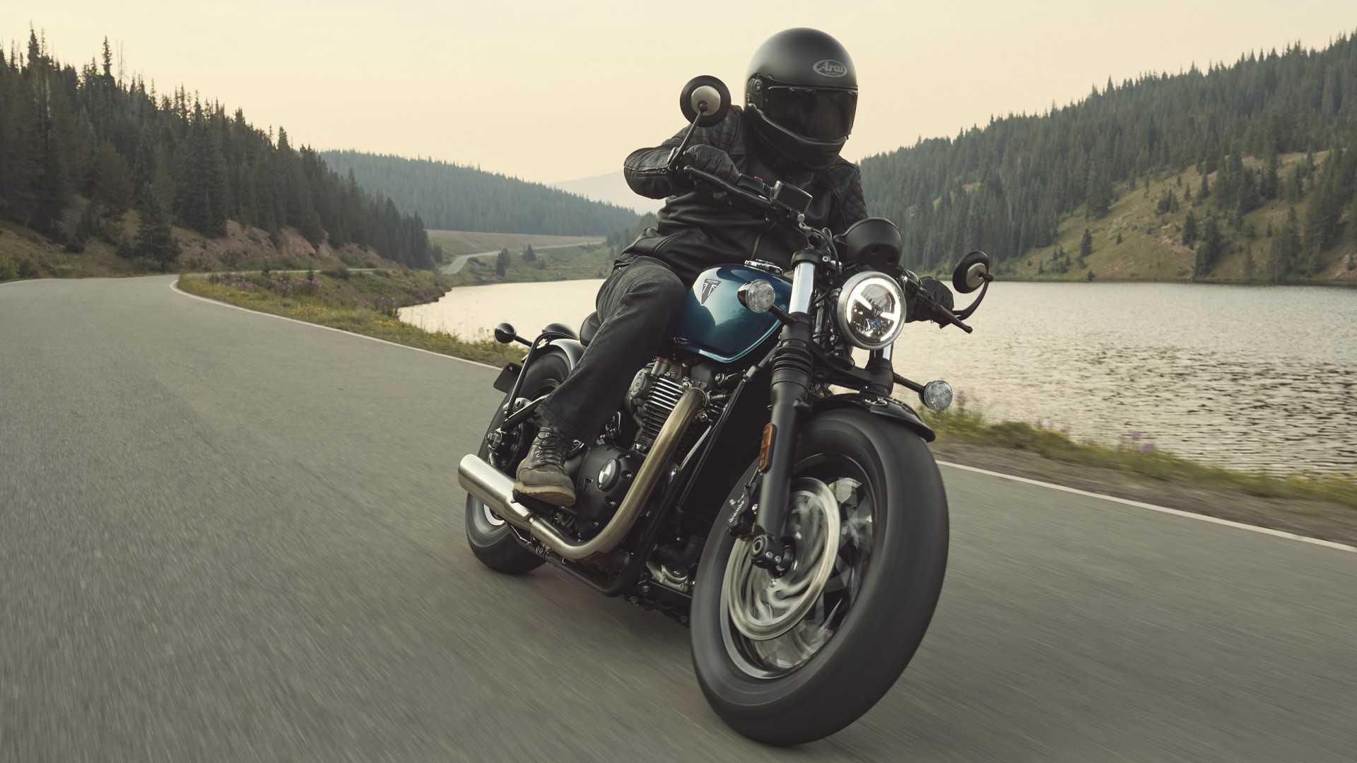 2026 Triumph Bonneville Bobber leaning along a winding mountain road front third quarter cinematic shot