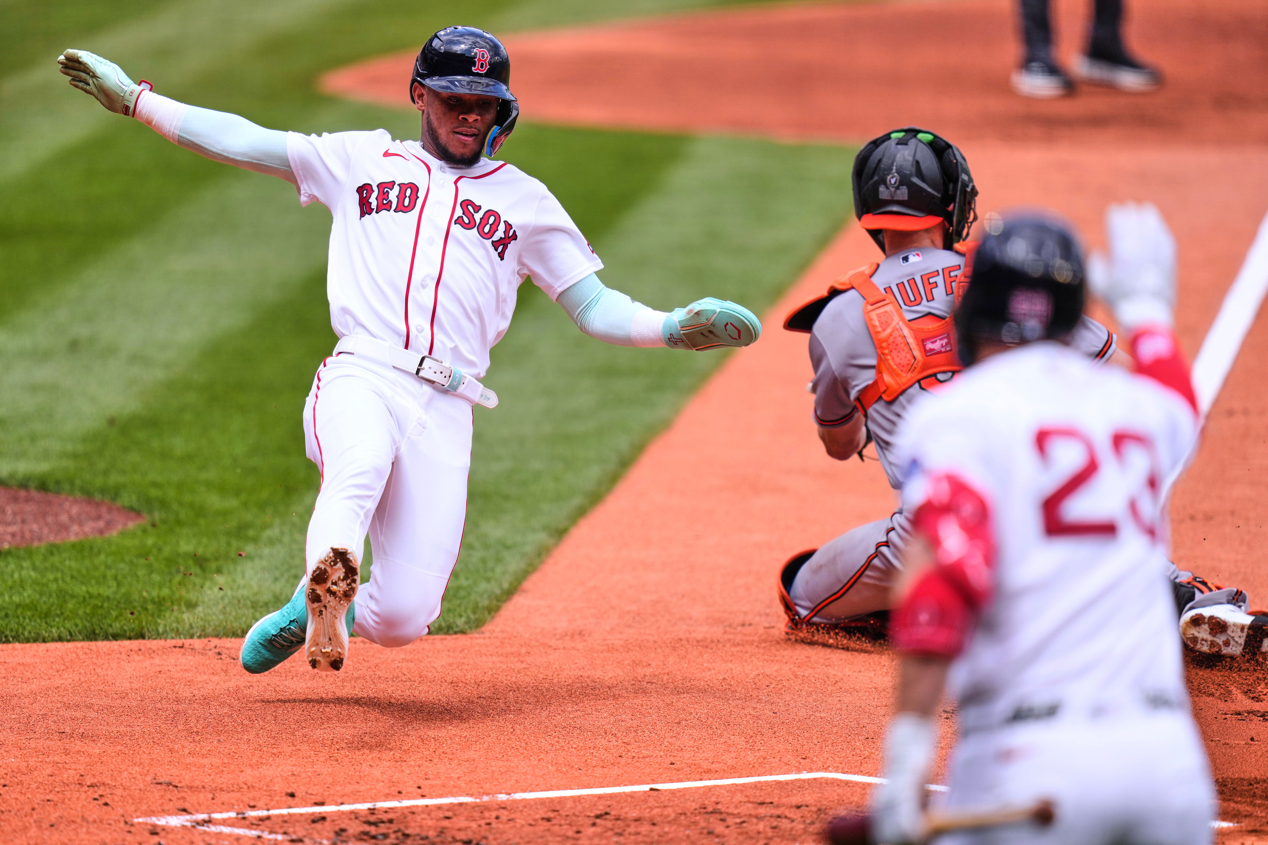 Boston Red Sox's Ceddanne Rafaela scores on a two-rn single by Caleb Durbin in the first inning during the first baseball game of a doubleheader against the Baltimore Orioles, Wednesday, July 22, 2026, in Boston. (AP Photo/Charles Krupa)