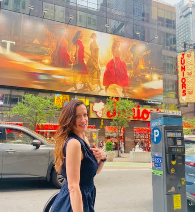 The author in front of a Times Square billboard advertising the third season of
