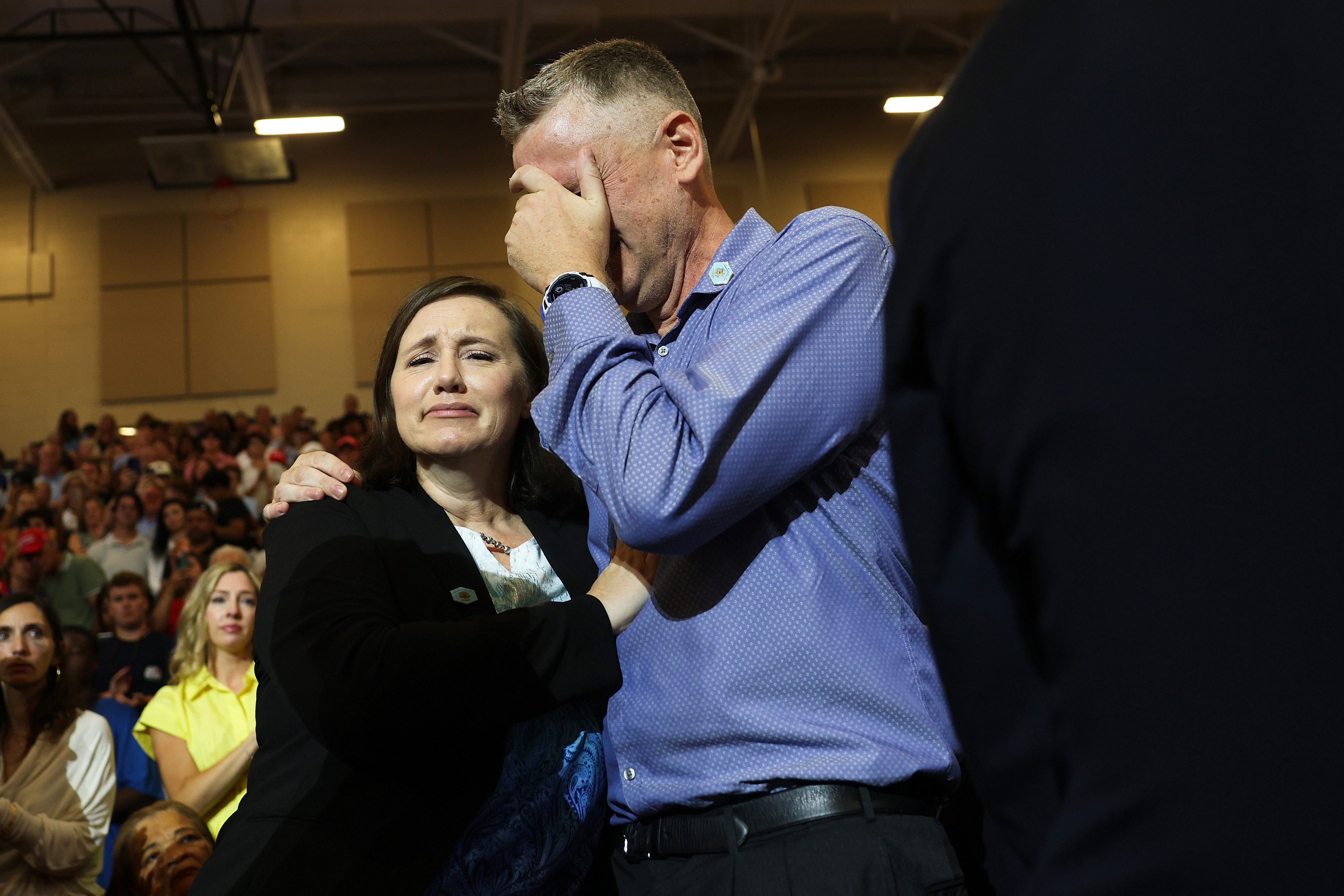 Stephen and Shari Feehan, the parents of U.S. Army 1st Lt Tyler James Feehan, become emotional as they are recognized by U.S. President Donald Trump as he speaks at Wheeler High School on July 22,...