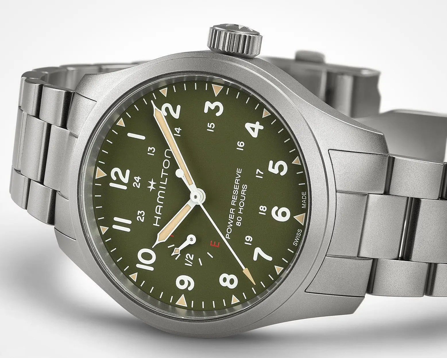 Silver Hamilton wristwatch with olive green dial, white numerals, and metal link bracelet.