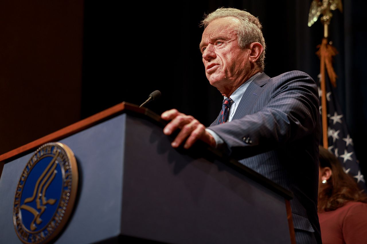 Robert F Kennedy Jr speaking at a podium during an event