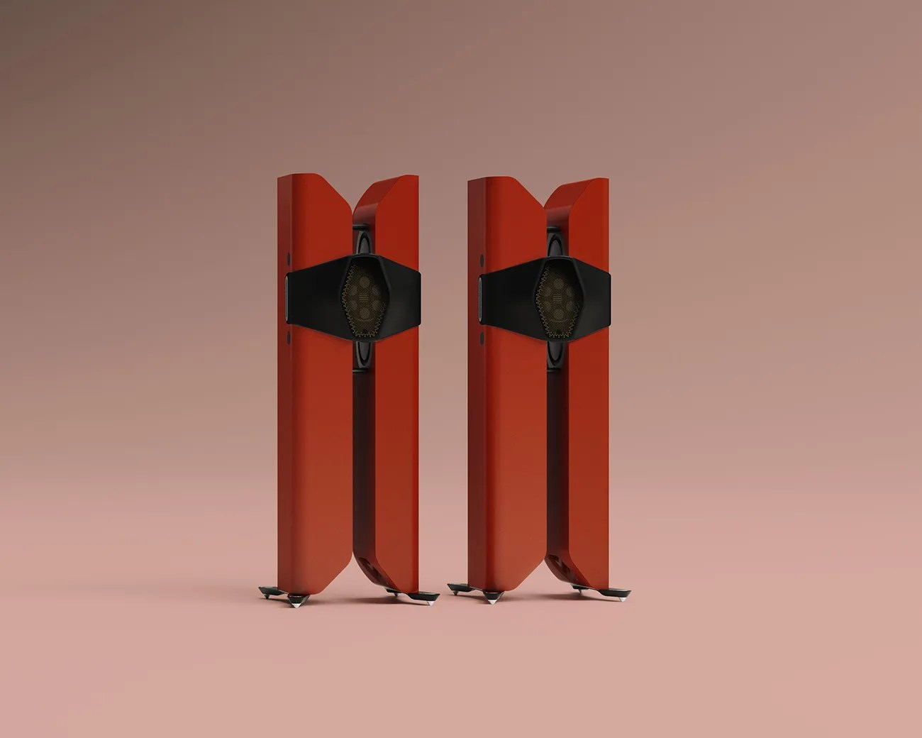 Pair of tall, red floor-standing speakers with black central grille and metal spike feet on a pink surface.
