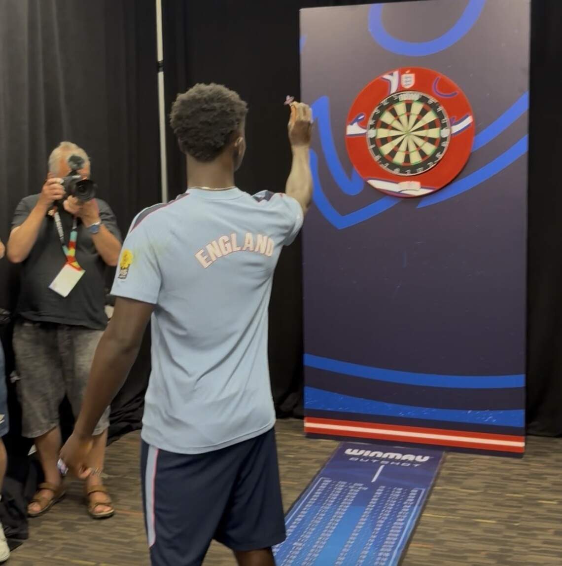 Weeks before his hat trick for England in the World Cup third-place match, Bukayo Saka tried his hand at darts in the Kansas City Parks and Recreation building.