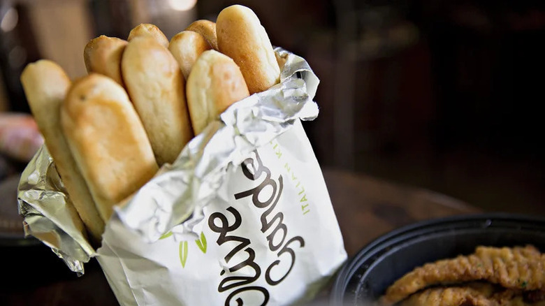 Basket of breadsticks wrapped in a cloth napkin