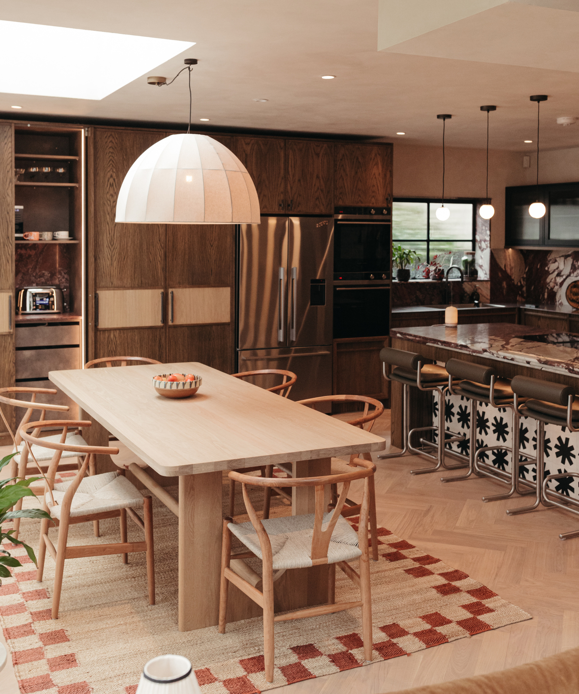Kitchen with wooden dining set and textured rug and patterned cabinet and wooden cabinetry