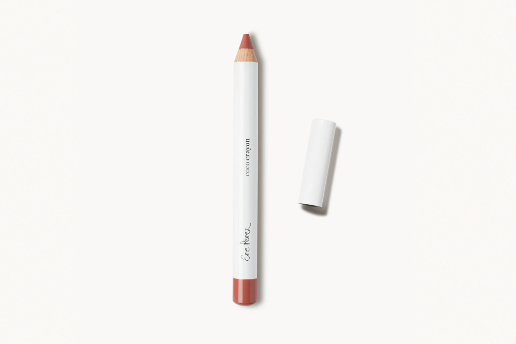Ere Perez Coco Crayon lip pencil in a terra cotta color, with its cap removed.