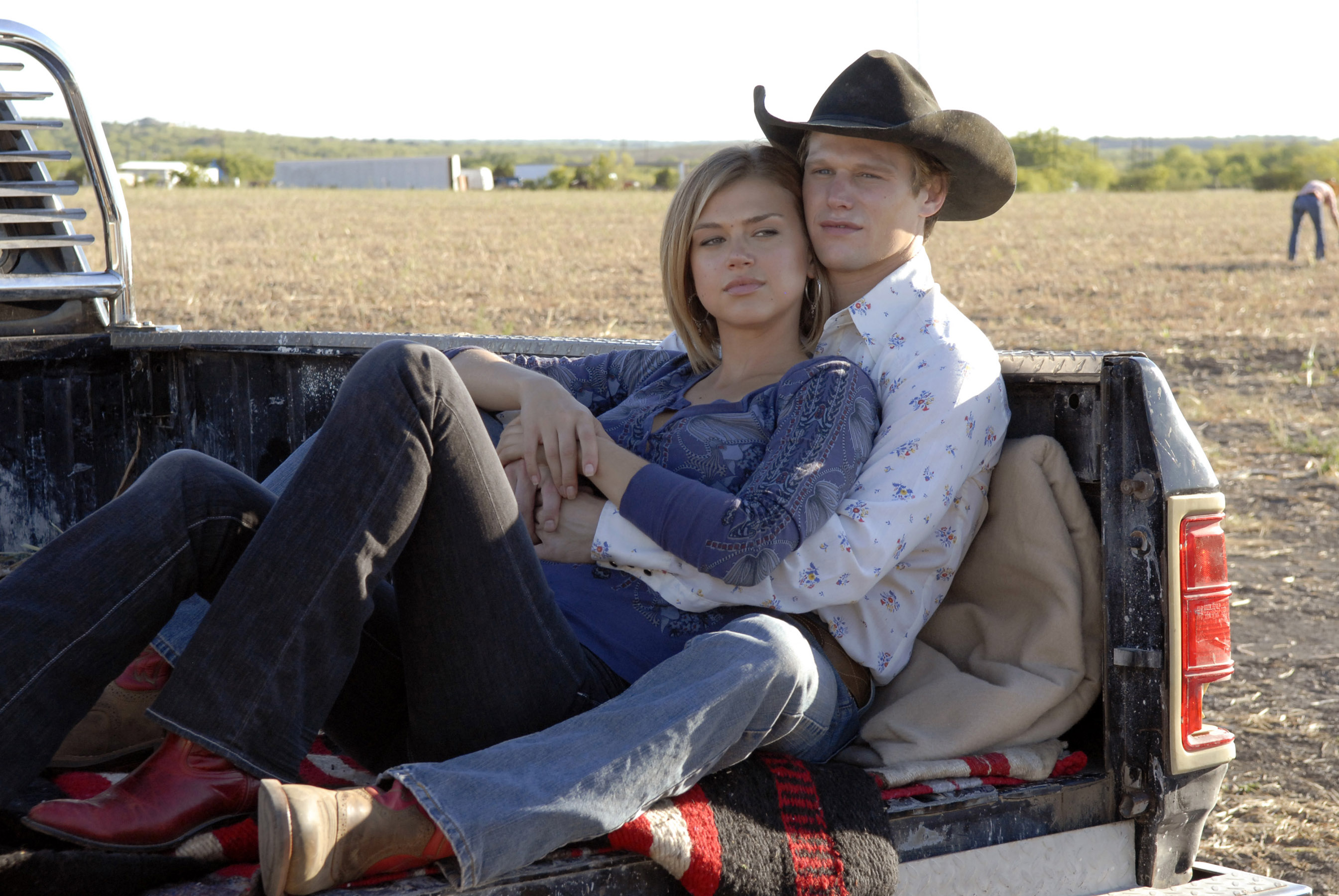 Adrianne Palicki and Zach Roerig in a truck bed in 