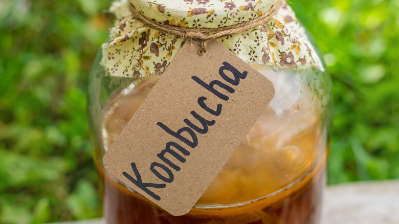A jar of kombucha with a hand-written label.