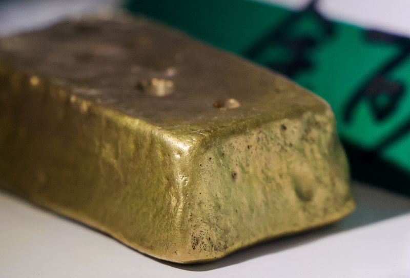 Gold off two-week peak as oil advances, Fed meeting eyed
