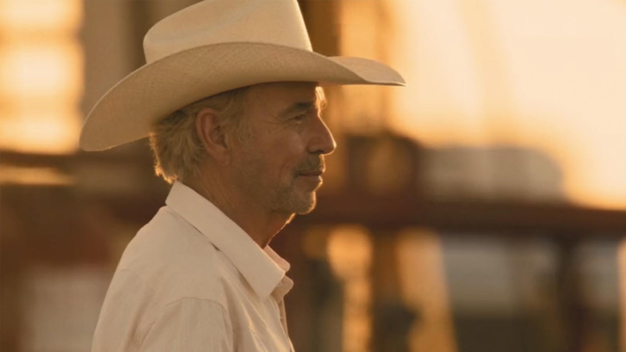 Billy Bob Thornton wearing a white cowboy hat and looking off to the right in Landman