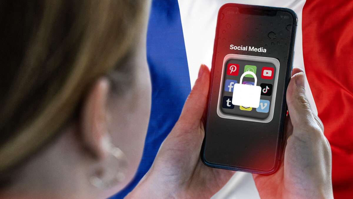 A person holds a smartphone that shows a folder of social media apps on the screen with a lock outline across it. The French flag is in the background. ©imageBROKER/Jochen Tack/Newscom/Adani Samat/Envato