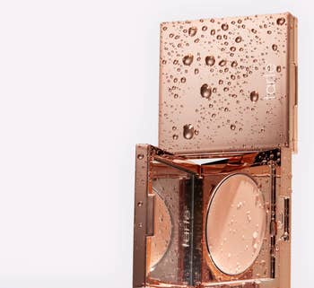 Makeup compact with a mirror and bronzer powder. Packaging features water droplets, highlighting a waterproof formula
