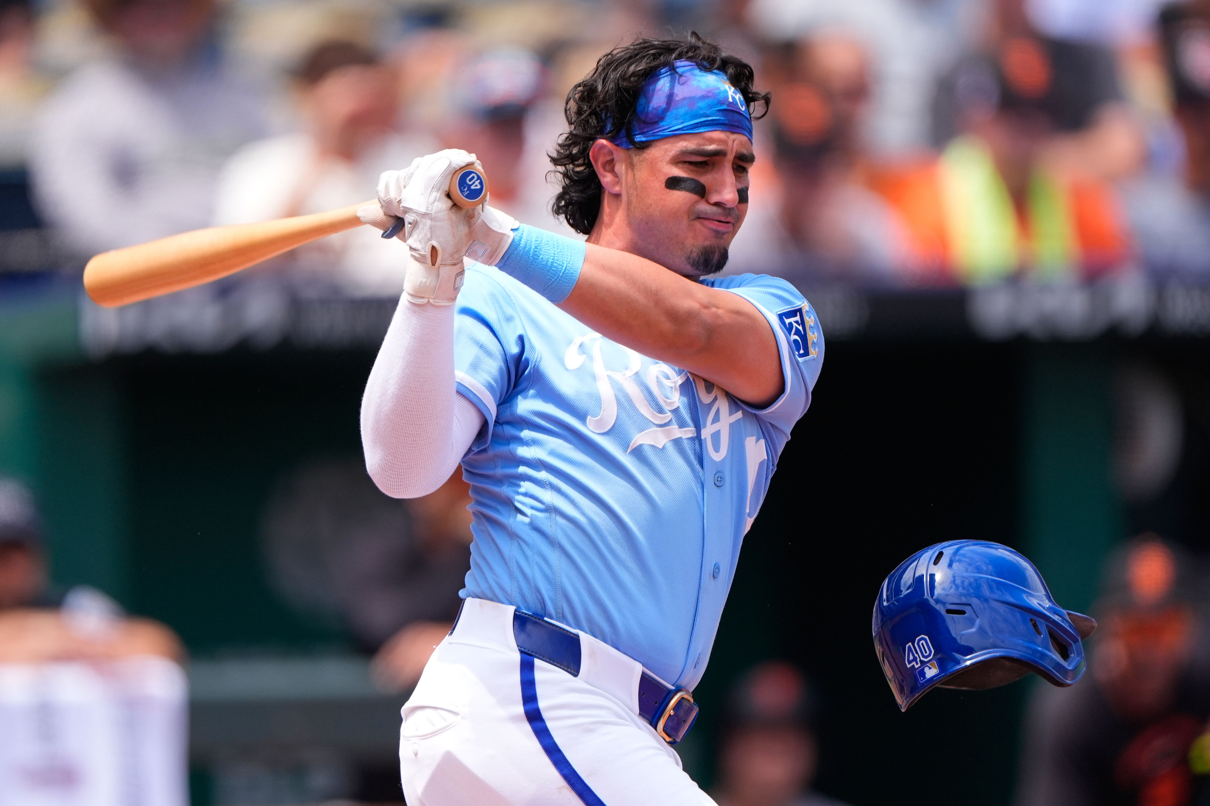 Kansas City Royals third baseman Josh Rojas looses his helmet as he bats during the third inning of a baseball game against the San Francisco Giants, Wednesday, July 22, 2026, in Kansas City, Mo. (AP Photo/Charlie Riedel)