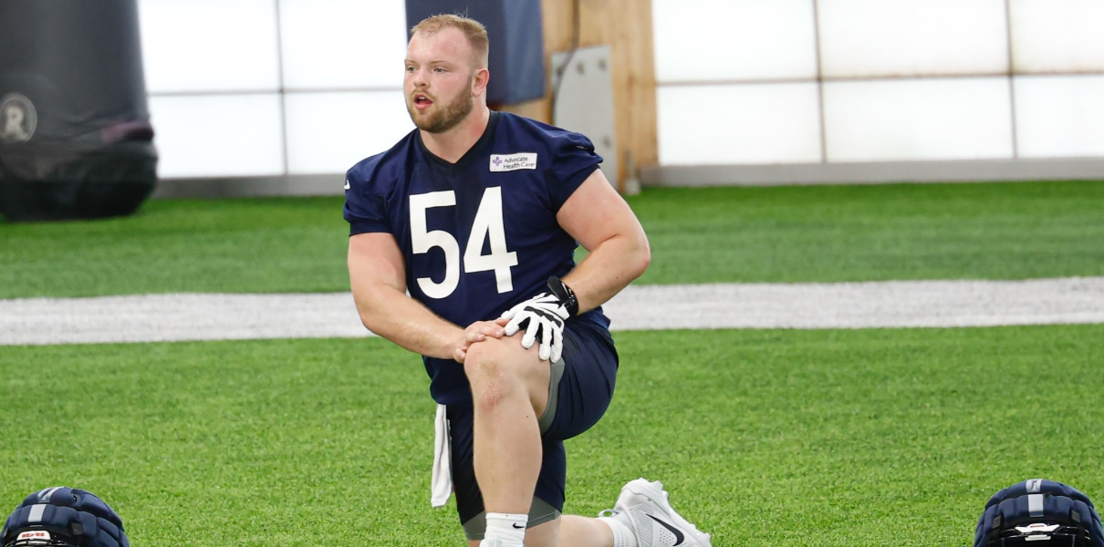 Bears center Logan Jones stretches during Rookie Minicamp at Halas Hall. Mandatory Credit: Kamil Krzaczynski-Imagn Images