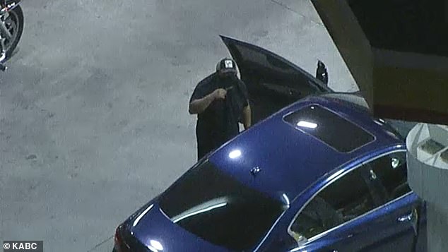He appeared to look directly at the news camera as he nervously paced around the car and covered his face while pumping gas