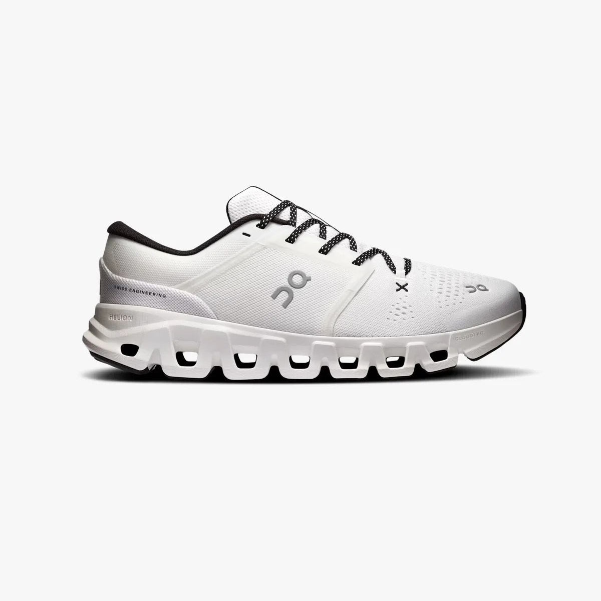 White On running shoe with black laces and a segmented sole featuring hollow rectangular cutouts.