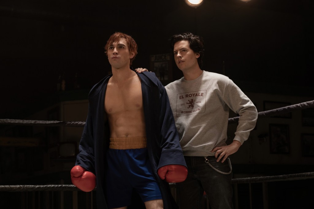 KJ Apa and Cole Sprouse in a boxing ring.