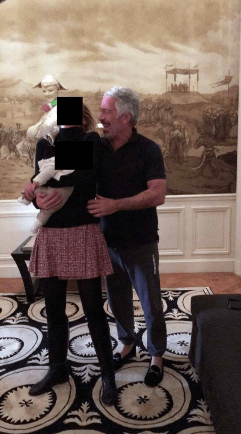 Jeffrey Epstein is seen embracing a blonde woman holding a baby who is reportedly the Child of deceased pedophile in these undated and redacted photograph released by the U.S. Department of Justice