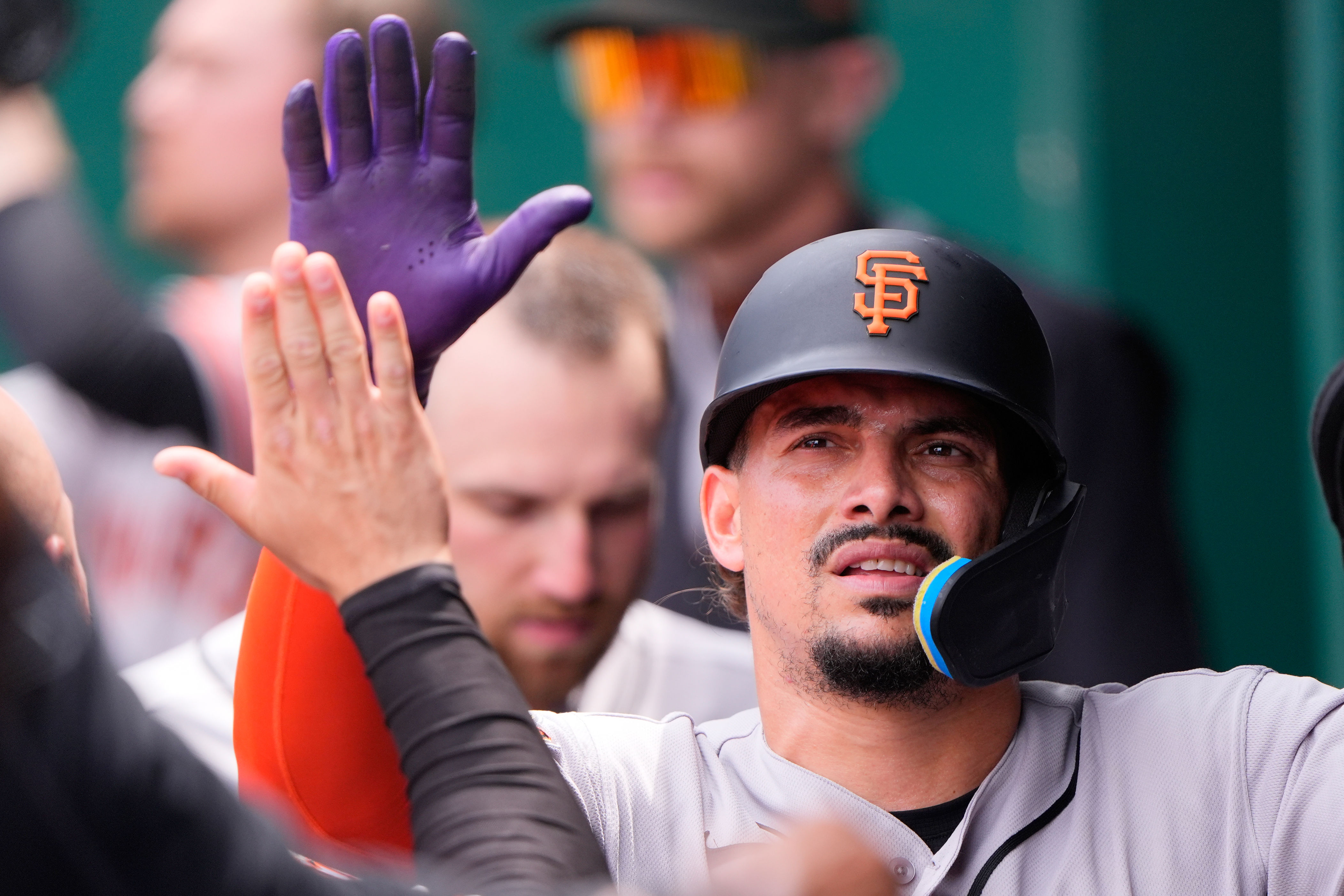 San Francisco Giants' Luis Arraez celebrates in the dugout after scoring on a sacrifice fly hit by Luis Arraez during the sixth inning of a baseball game against the Kansas City Royals, Wednesday, July 22, 2026, in Kansas City, Mo. (AP Photo/Charlie Riedel)