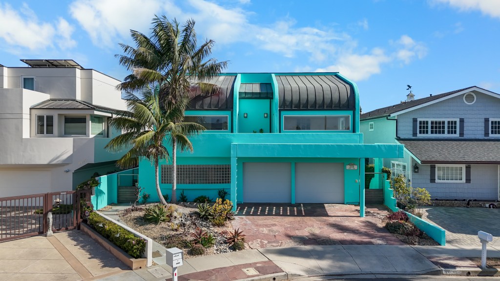 LA : Miami Vice style home .A breathtaking contemporary architectural masterpiece commands attention from the moment you arrive at the end of a peaceful cul-de-sac, where striking design, sculptural landscaping, swaying palms, a tranquil river rock stream, and custom metal gates create an unforgettable first impression. Perfectly positioned on one of Mandalay Bay's coveted wide secondary channels with a 50-foot boat dock easement, this extraordinary waterfront residence blends sophisticated design with effortless coastal living.