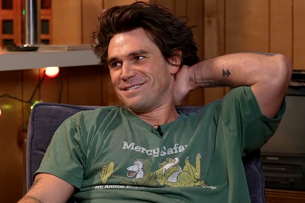 A man in a green T-shirt with the text