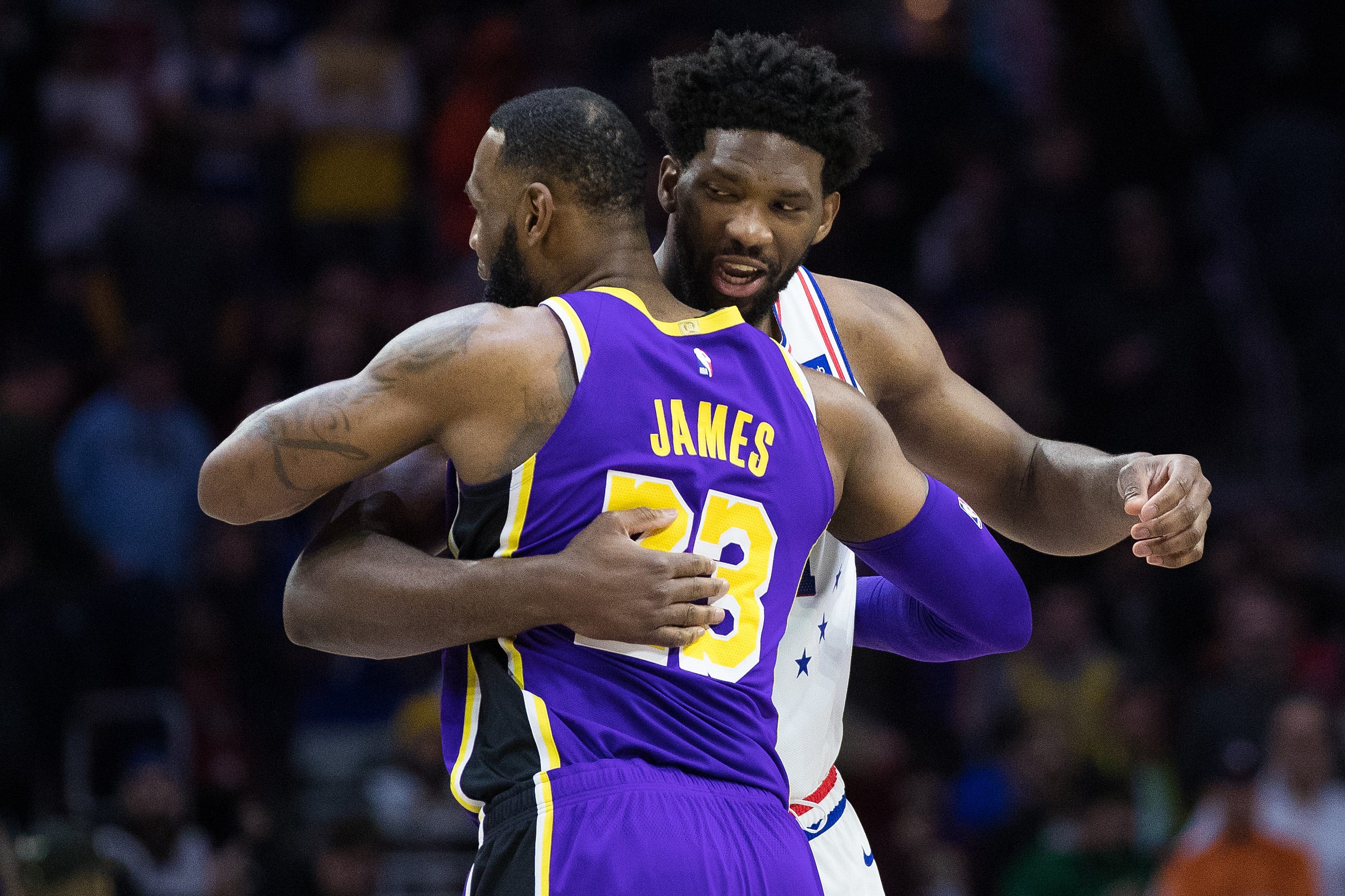 Feb 10, 2019; Philadelphia, PA, USA; Philadelphia 76ers center Joel Embiid (21) and Los Angeles Lakers forward LeBron James (23) embrace before the first quarter at Wells Fargo Center. Mandatory Credit: Bill Streicher-USA TODAY Sports