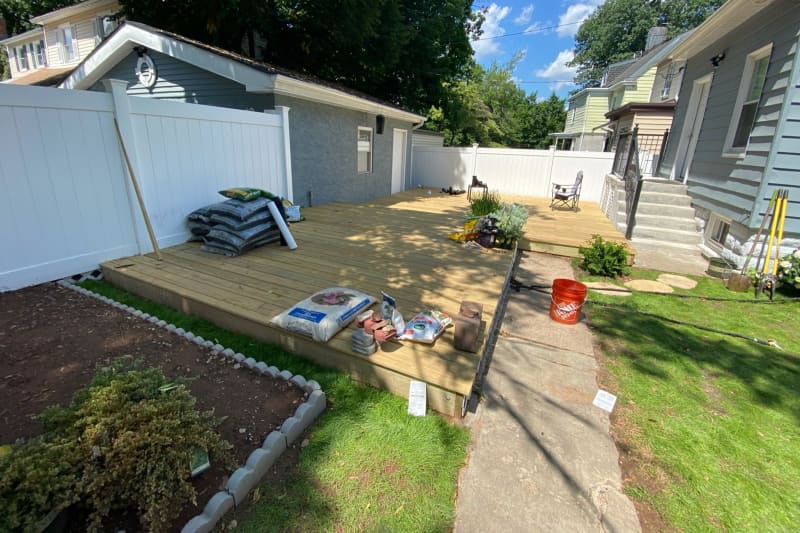 Wooden deck added over concrete backyard area during renovation.
