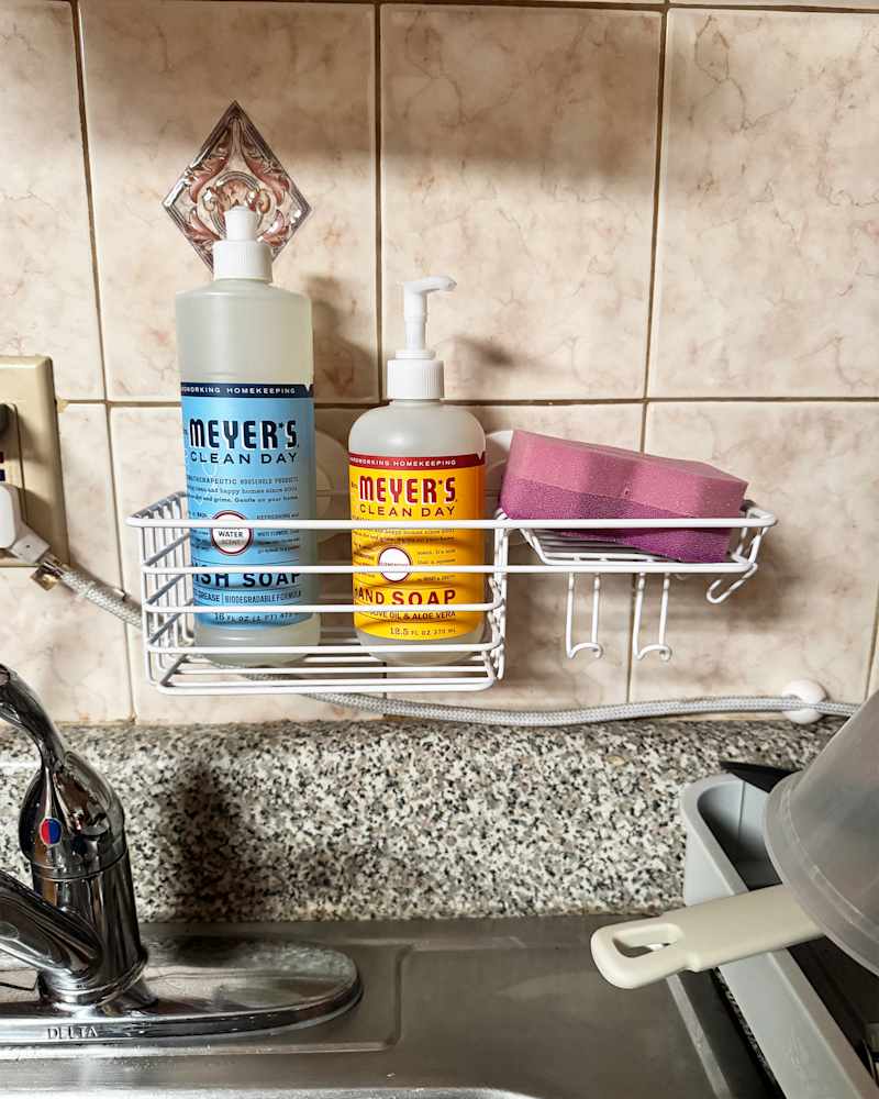 Dish soap in shower caddy above kitchen sink.