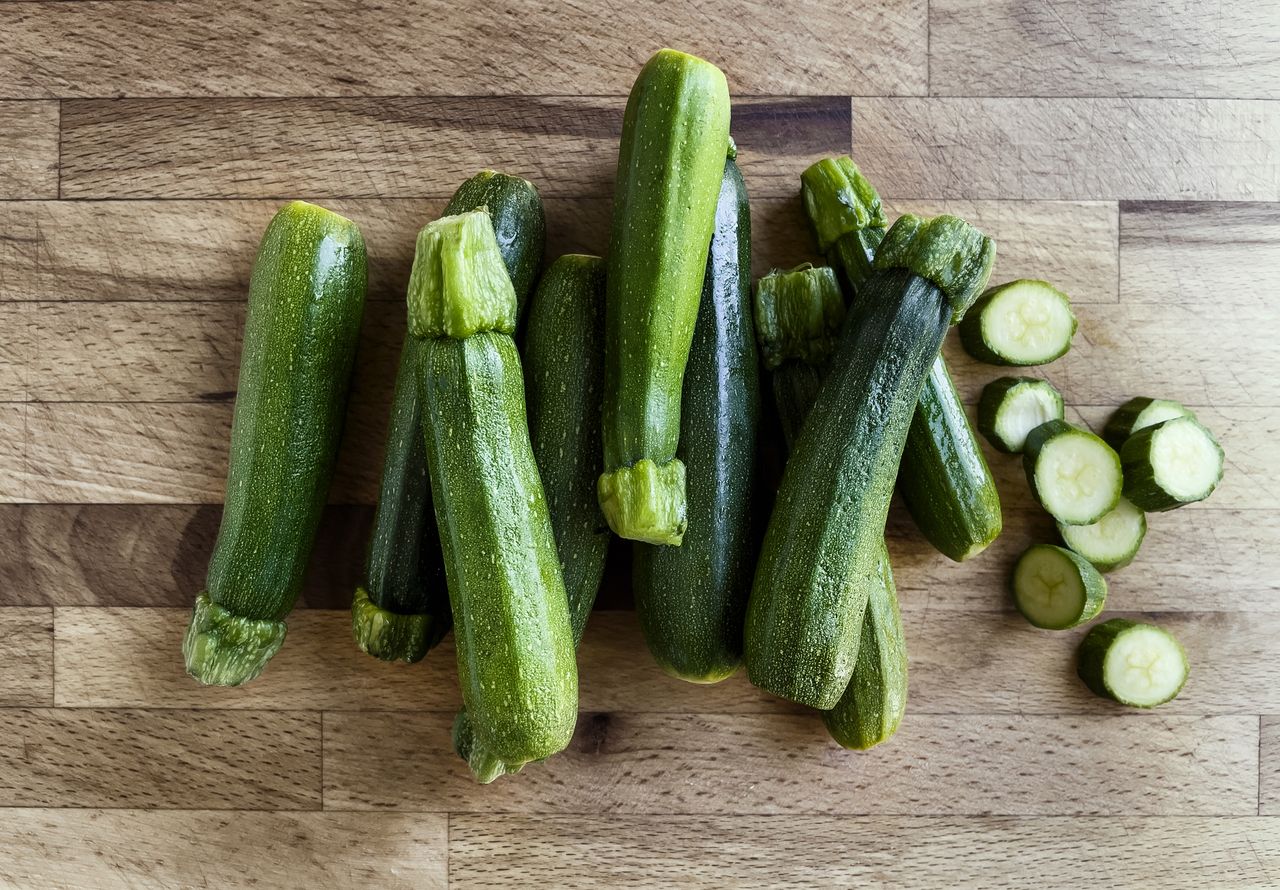 A bunch of zucchini on a wooden table