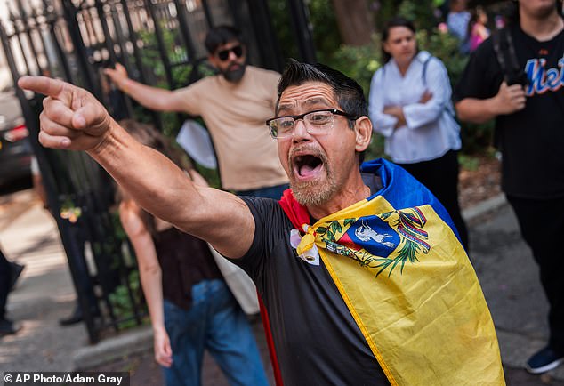 A Venezuelan man, who is in opposition to former Venezuela President Nicolas Maduro and his wife Cilia Flores, shouts at pro-Maduro protestors outside of Manhattan federal court on Wednesdat