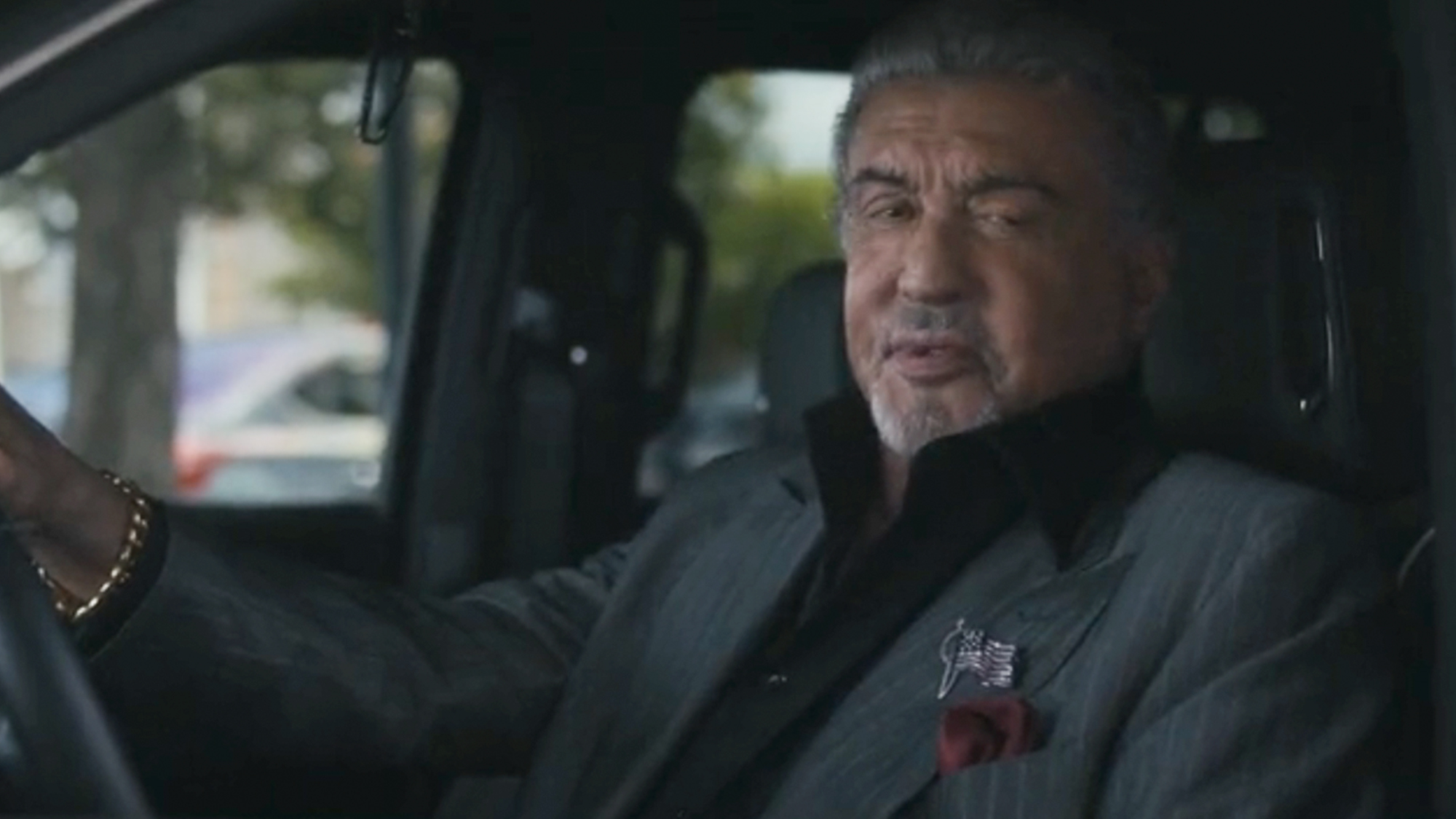 Sylvester Stallone looking out of a car window in Tulsa King
