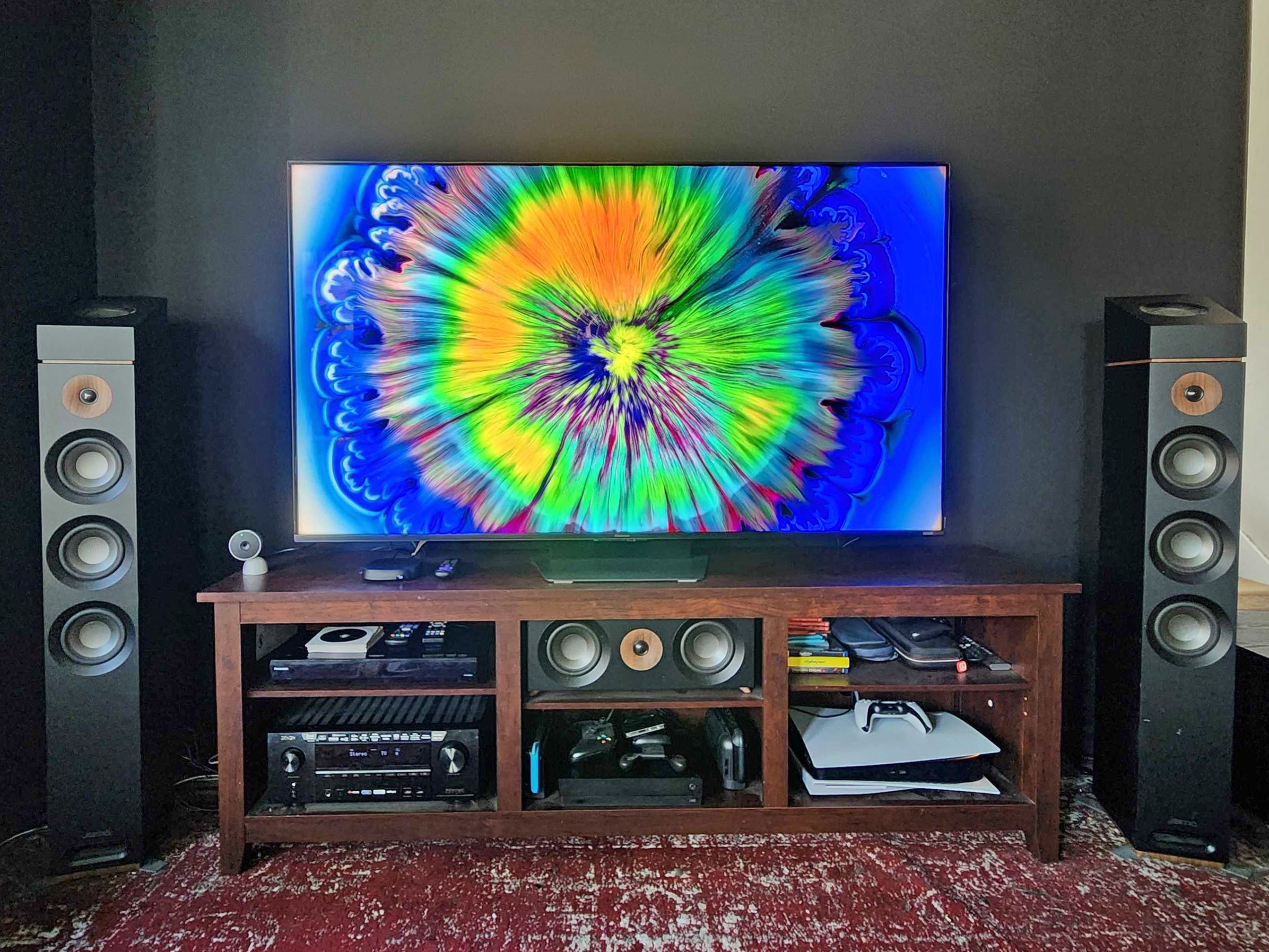 A Hisense UR9 RGB Mini LED TV in our reviewer's living room, with a video of swirling colors on the screen.