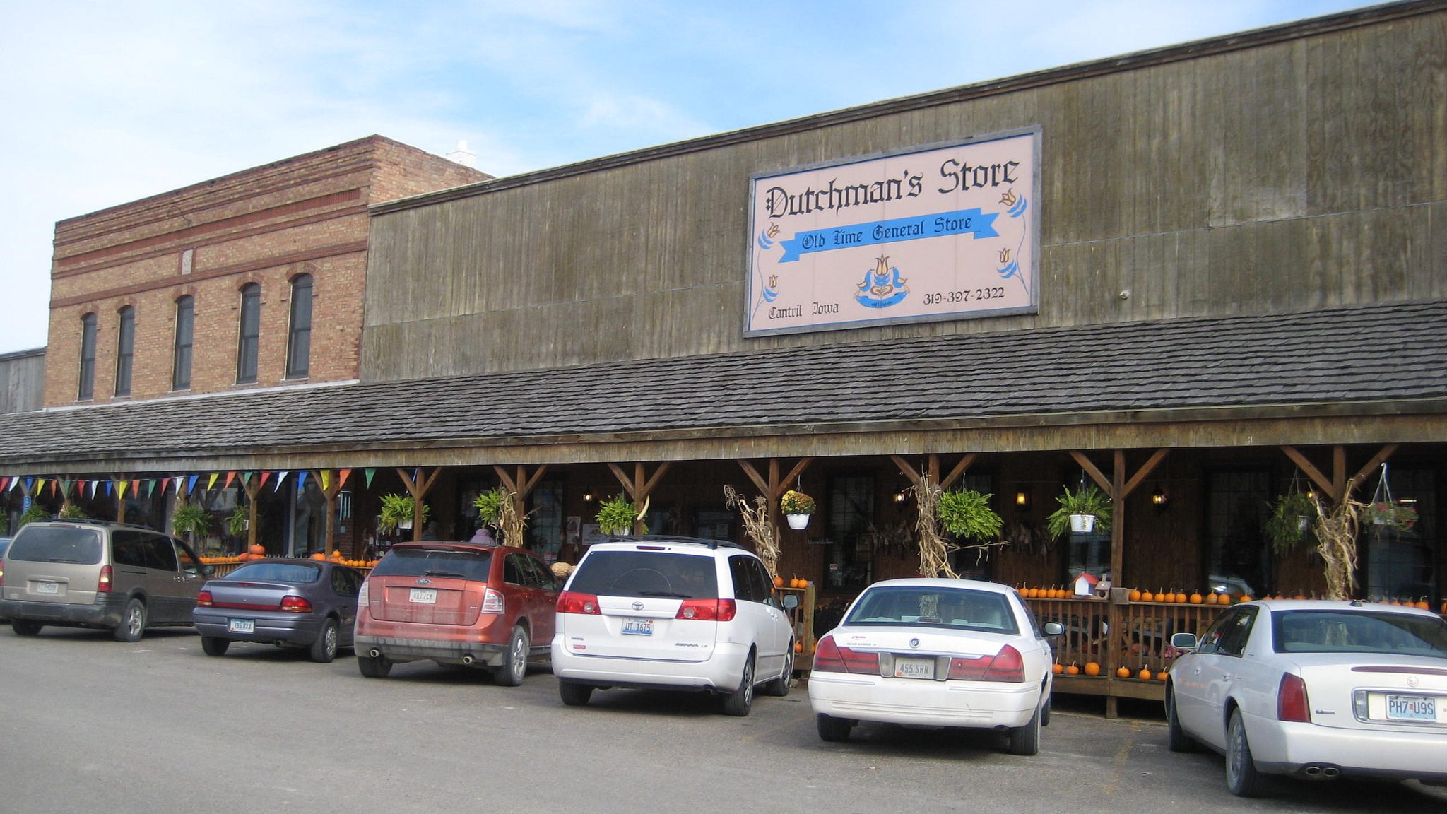 cars parked on the street in front of Dutchman's Store in Cantril, Iowa