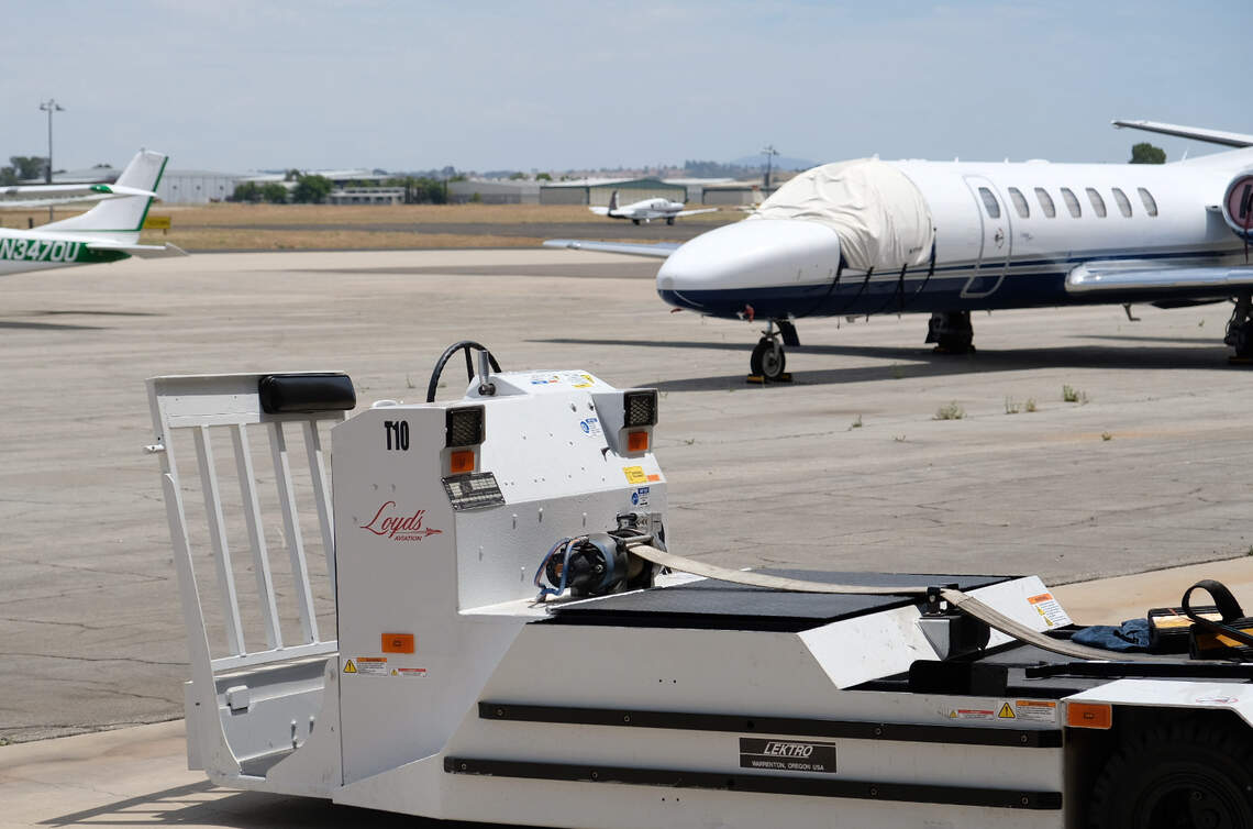 A covered plane sits in the background near the Loyd’s Aviation maintenance shop at the Paso Robles Airport on July 13, 2026. Loyd’s Aviation has hired graduates from Cuesta College’s aircraft maintenance technician training program.
