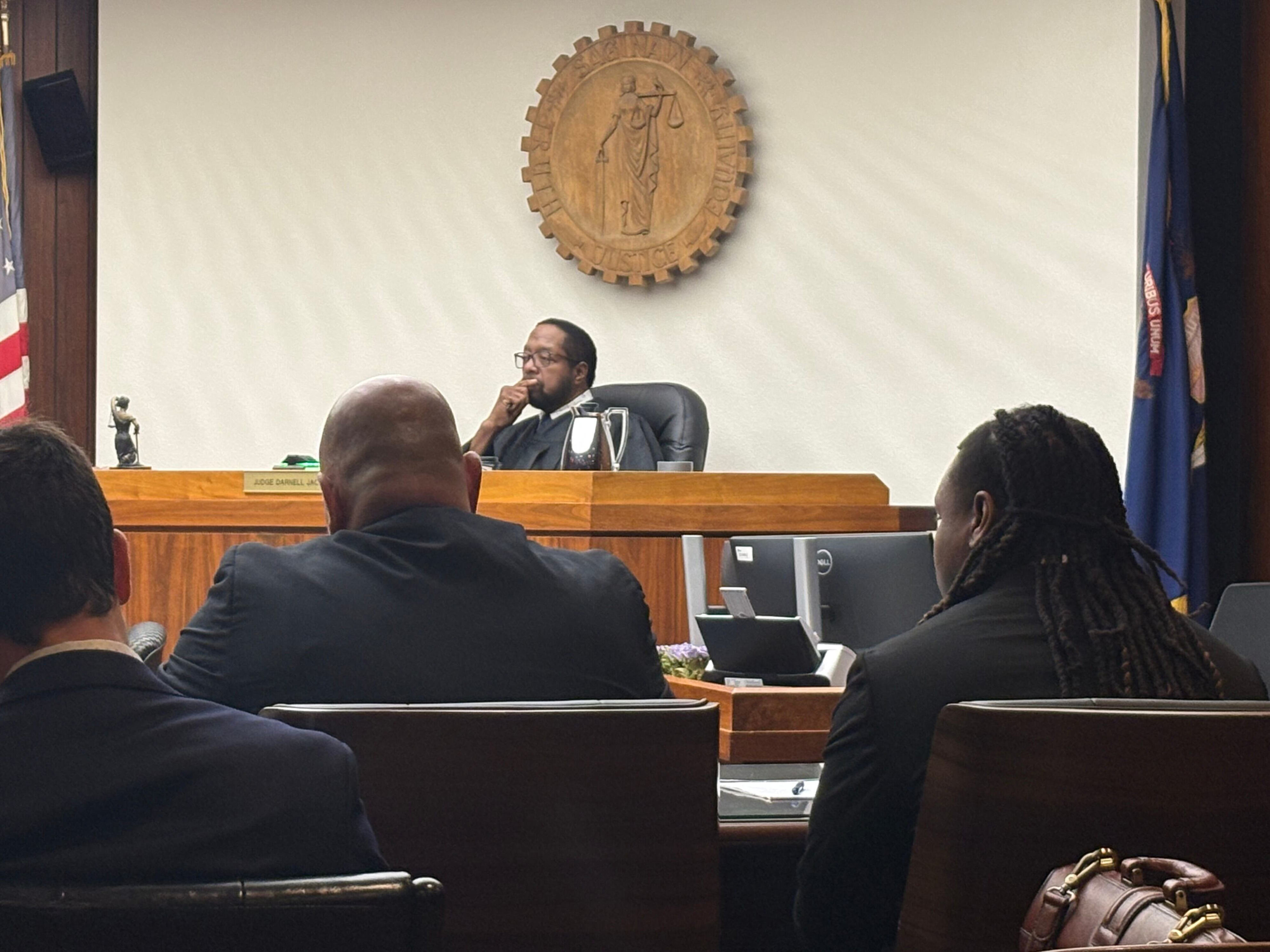 Shavar S. Craft Jr. (right) sits at the defense table beside attorney Robert Hinojosa during his trial on murder, assault with intent to murder, and firearms charges in Saginaw County Circuit Court on July 22, 2026. Craft is accused of shooting 25-year-old Da'Quan L. Mims 11 times, killing him, outside West Side Party Store on June 16, 2024. Judge Darnell Jackson presides.
