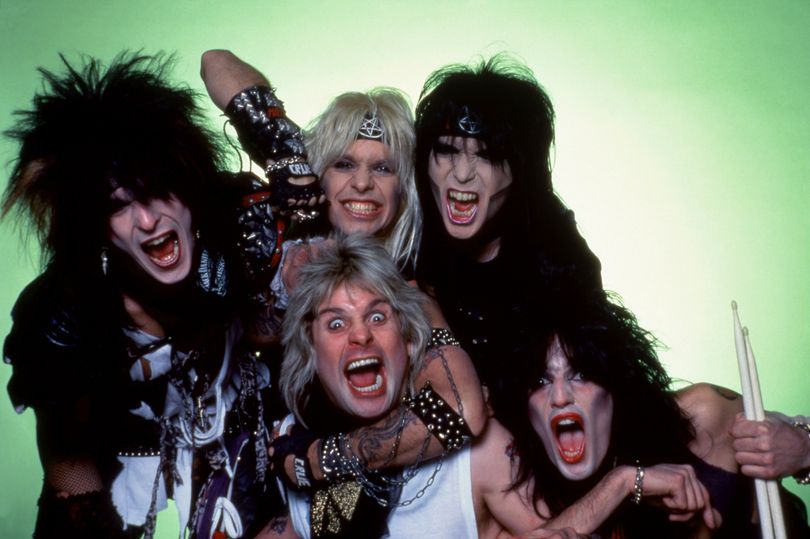 Bassist Nikki Sixx, lead singer Vince Neil, lead guitarist Mick Mars and drummer Tommy Lee of the American hard rock band Motley Crue pose for a studio portrait with Ozzy Osbourne during Ozzy's Bark at the Moon Tour on March 6, 1984