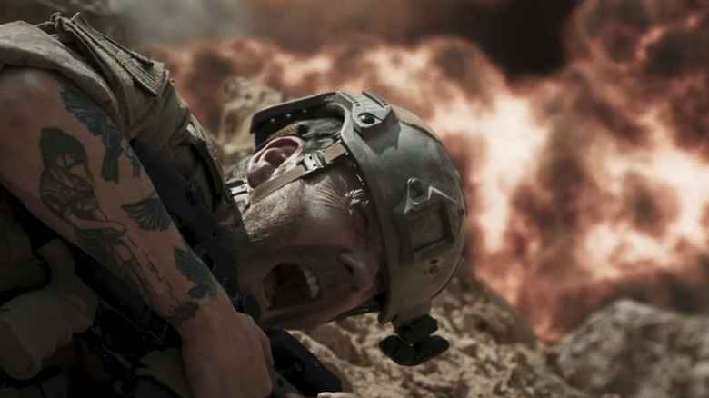 Kiefer Sutherland's Capt. Jordan Wright screams as he lays on the floor while an explosion goes off in the background in Brothers Under Fire