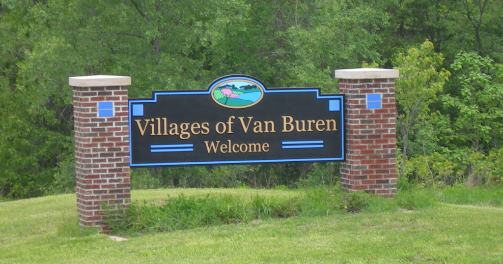 a roadside sign welcoming travelers to the villages of van buren in iowa