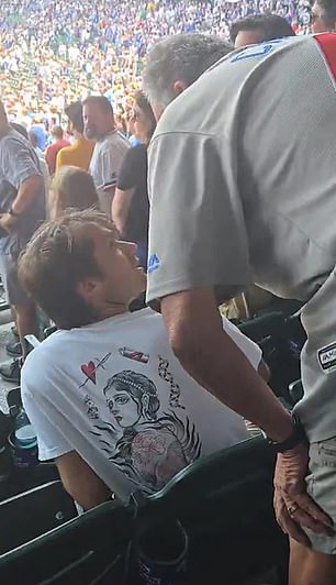 Before the slap, the older man had leaned over the young man to demand he stands up