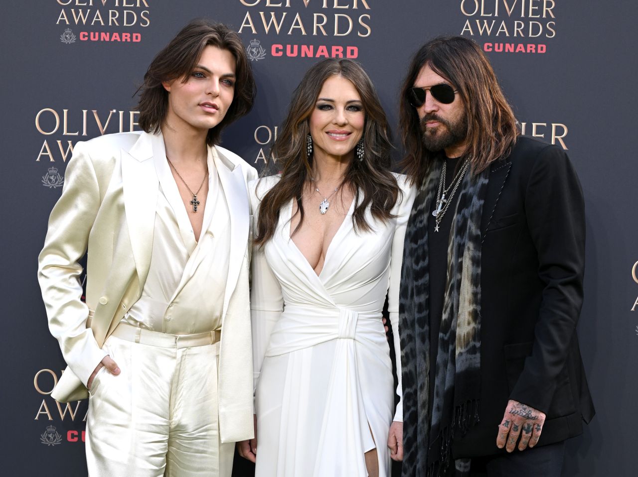 Damian Hurley Elizabeth Hurley and Billy Ray Cyrus standing together at the Olivier Awards