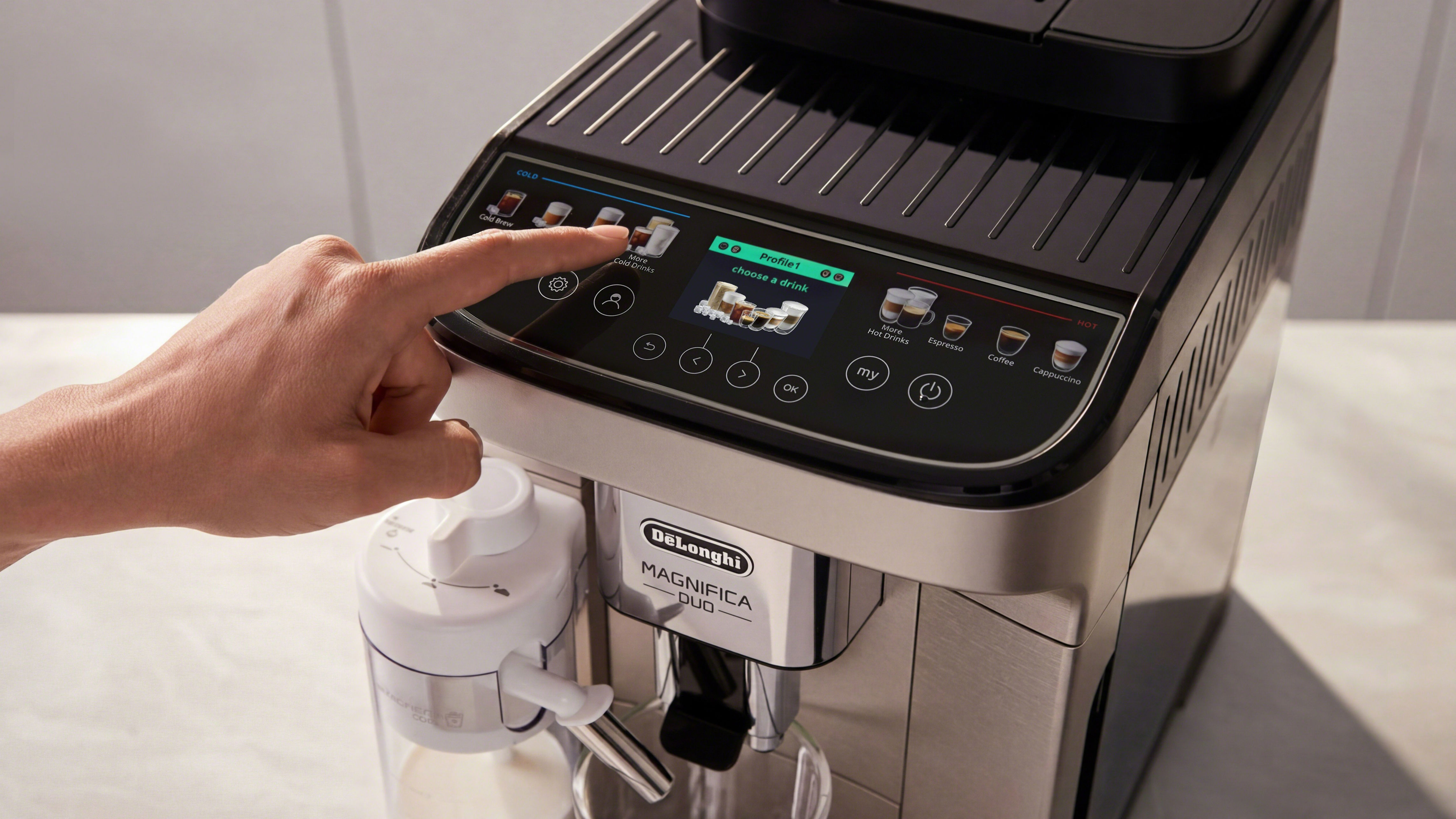 Person pressing button on De'Longhi Magnifica Duo coffee maker