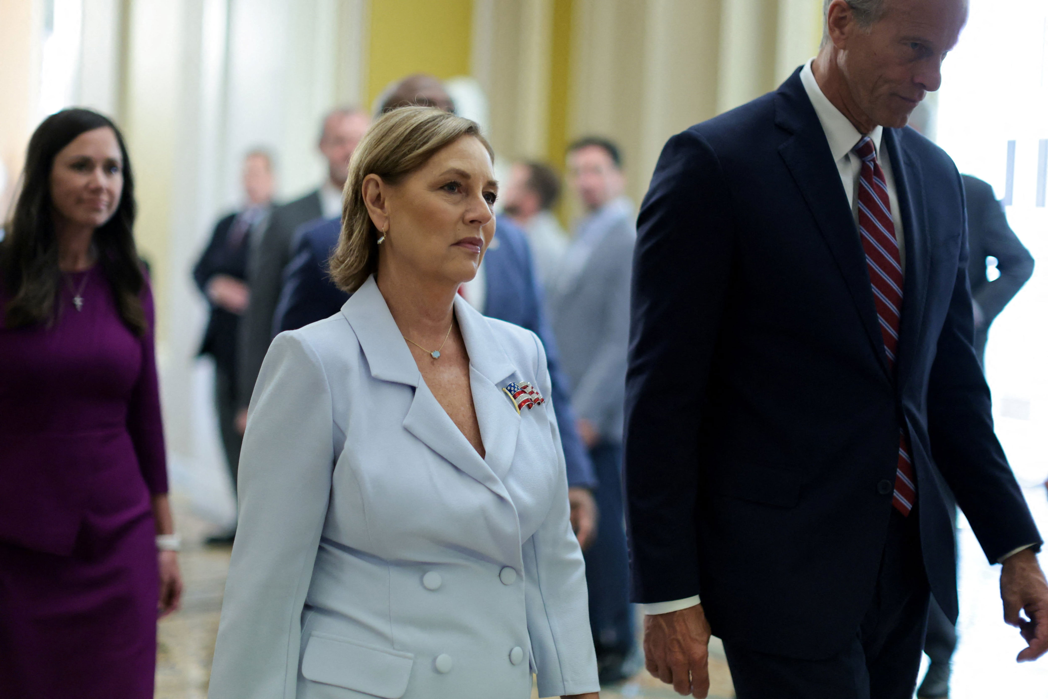 Darline Graham walking with Senate Majority Leader John Thune, who has poured cold water on Trump's SAVE Act aspirations. / Jonathan Ernst / REUTERS