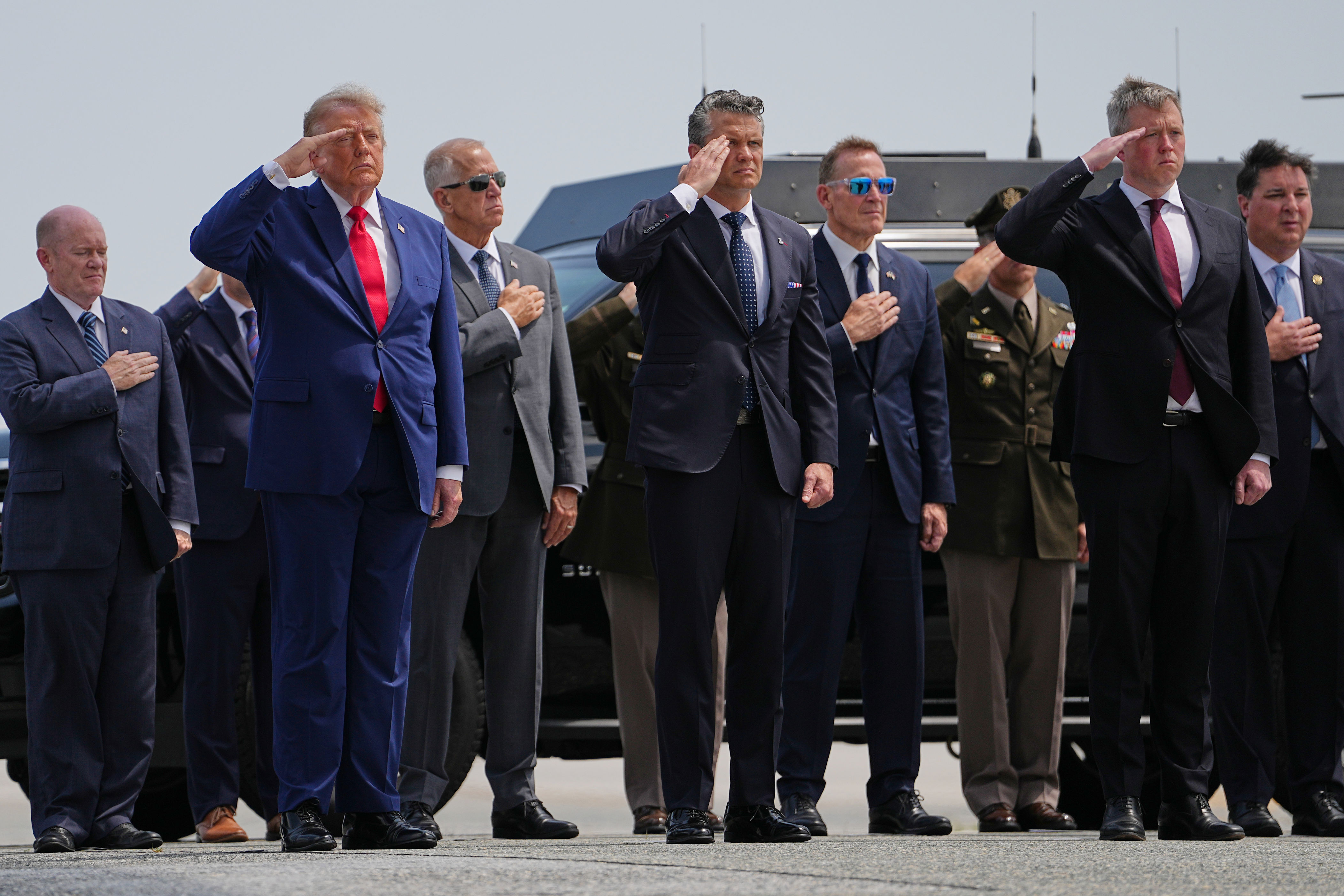President Donald Trump, Secretary of Defense Pete Hegseth and others, salutes as a U.S. Army carry team moves a transfer case containing the remains of Pvt. Isabella Gonzales of Carrollton, Texas, Wednesday, July 22, 2026, at Dover Air Force Base, Del. (AP Photo/Matt Rourke)