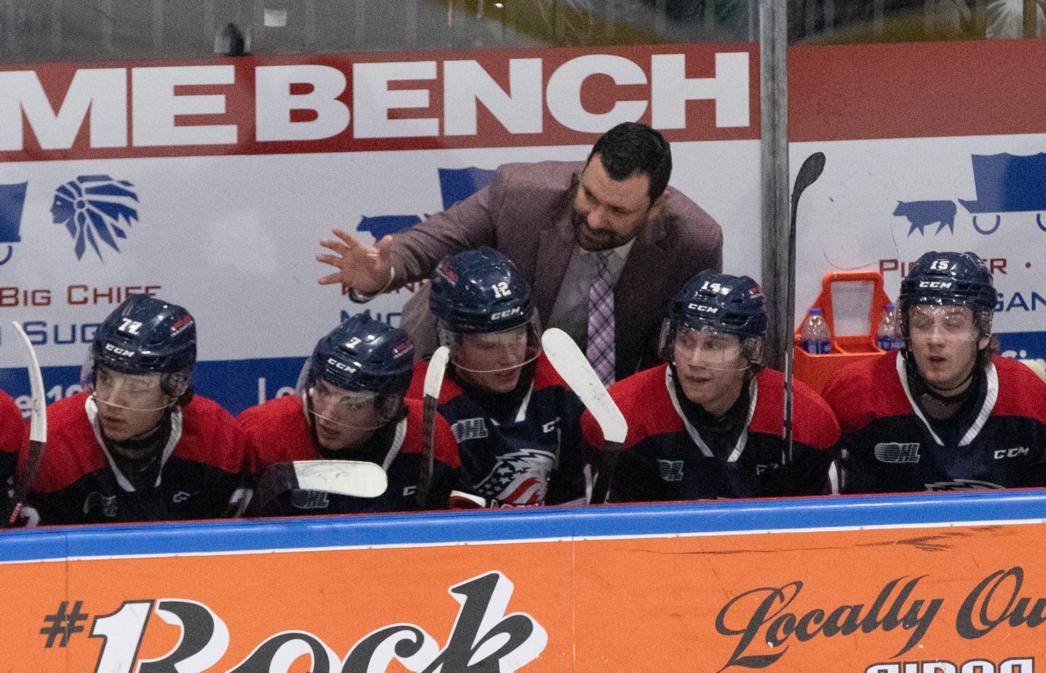 Saginaw Spirits head coach Chris Lazary talks to his team during a OHL playoff game against the Flint Firebirds on Thursday, March 30, 2023, at the Dow Event Center in Saginaw. The Saginaw Spirit won the game with a final score of 7-1.