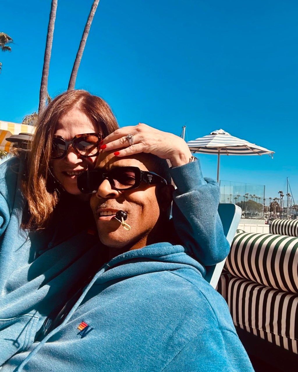James Morgan and Kim Delaney posing together outdoors.