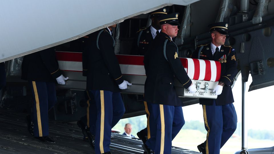 Members of a US Army carry team move the flag-draped transfer case holding the remains of Army Pvt. Isabella Gonzales, of Carrollton, Texas, during a dignified transfer at Dover Air Force Base on Wednesday. - Kevin Dietsch/Getty Images