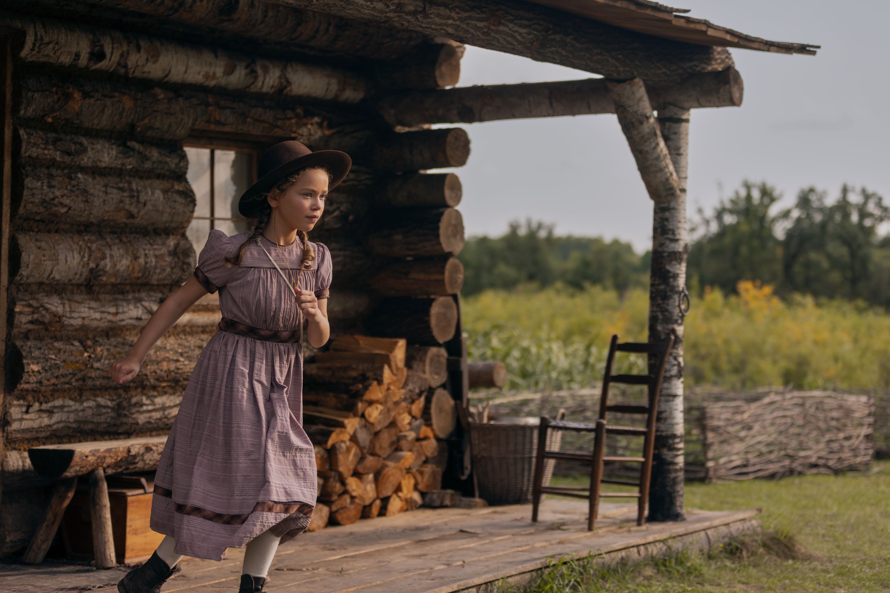 Alice Halsey as Laura Ingalls coming out of the family cabin, which was built with real logs and without nails.