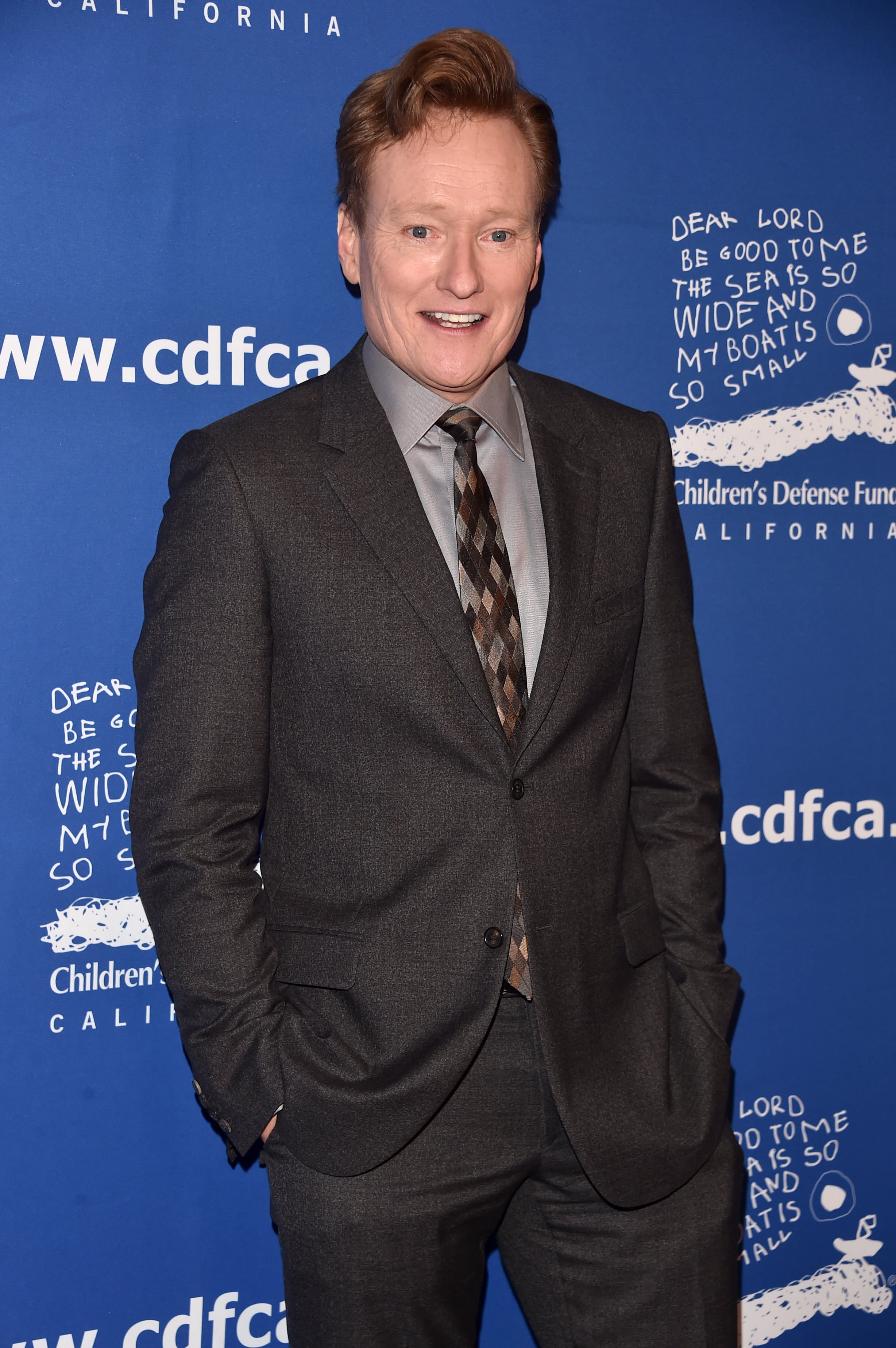 Host Conan O'Brien attends an event in 2026 in Beverly Hills, California, where he wore his usual pompadour and gray suit. / Alberto E. Rodriguez / Getty Images